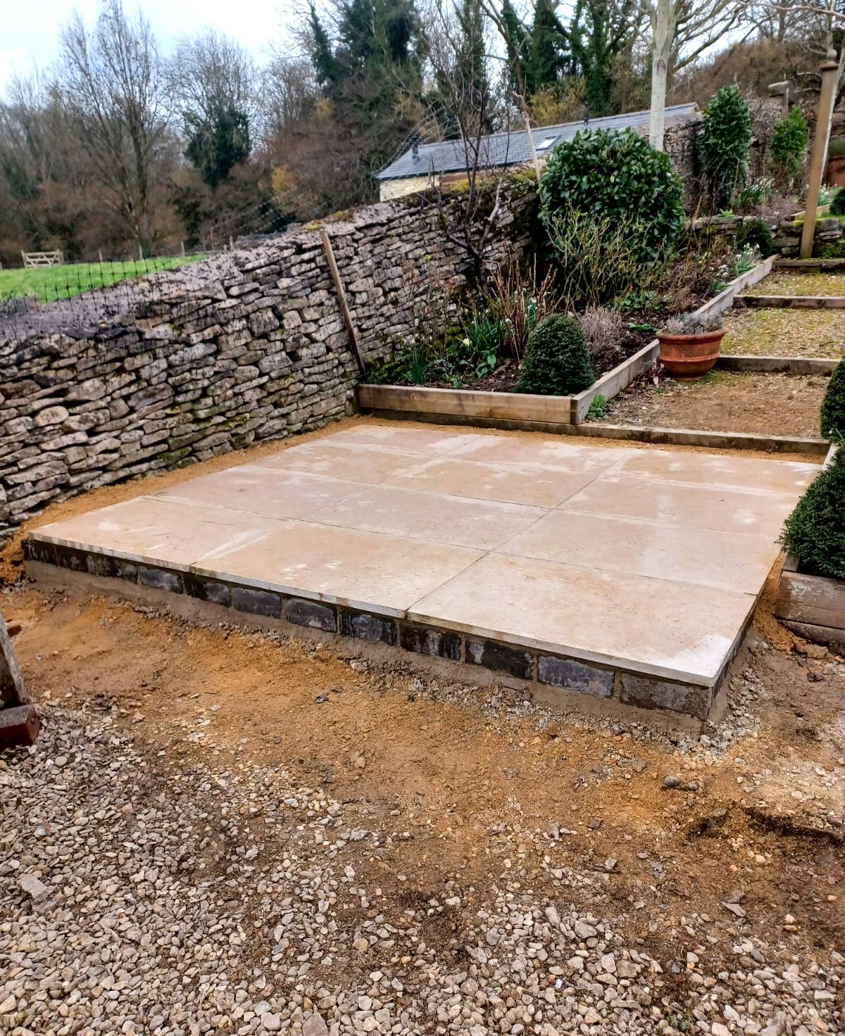 Square raised stone patio platform