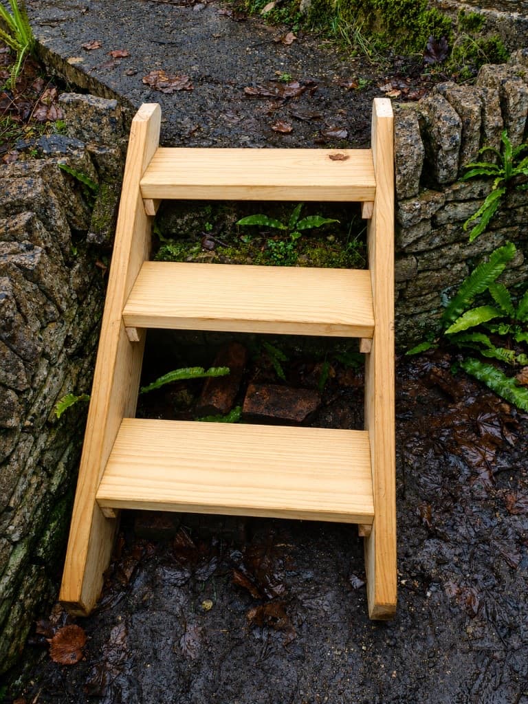 New light timber steps set into a dry stone wall